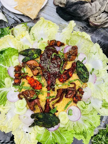 Another variation of our Mutton Mandi platter, showcasing different cuts of meat and kebabs on a bed of rice.