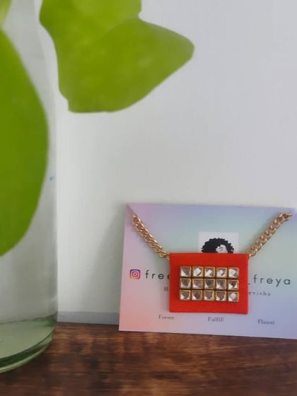 A simple and elegant fabric necklace with a square Kundan pendant. This piece is perfect for both western and traditional outfits, adding a touch of sparkle to your look.