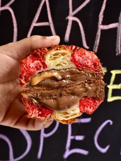The rich, gooey center of our Chocolate-Hazelnut Bloom Croissant. The combination of milk chocolate mousse and hazelnut praline inside the flaky, buttery layers is pure bliss.