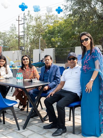Family and friends relaxing at the outdoor seating area during a large-scale Frozen and Football themed event.