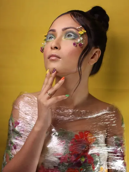 An editorial look inspired by spring, using real floral elements and a plastic wrap texture to create a unique visual.