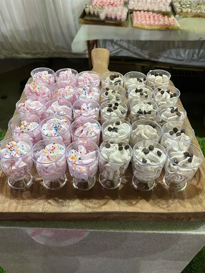 Individual dessert cups filled with strawberry and chocolate mousse, topped with sprinkles and chocolate chips.