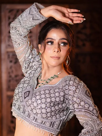 A complete look at my silver-grey geometric lehenga from a professional shoot. You can see the intricate details, the stylish back, and how it moves. It's a true work of art.