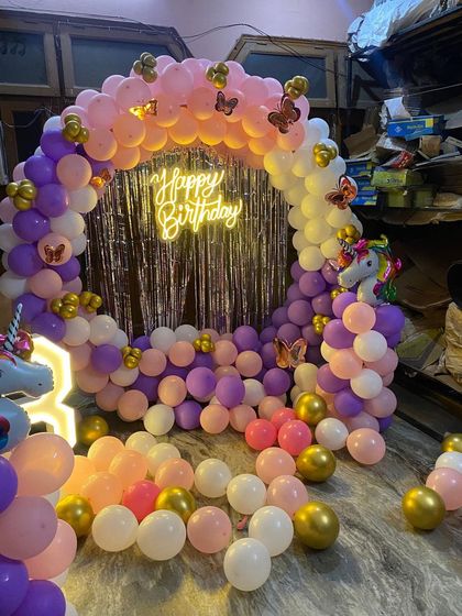 A wide shot of the unicorn-themed party setup in a room.