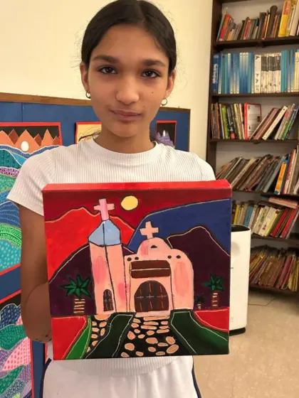 I love seeing my students take on challenging projects. This teen proudly displays her folk-style Mexican church painting, a wonderful piece from our 'Project Mexico' series.