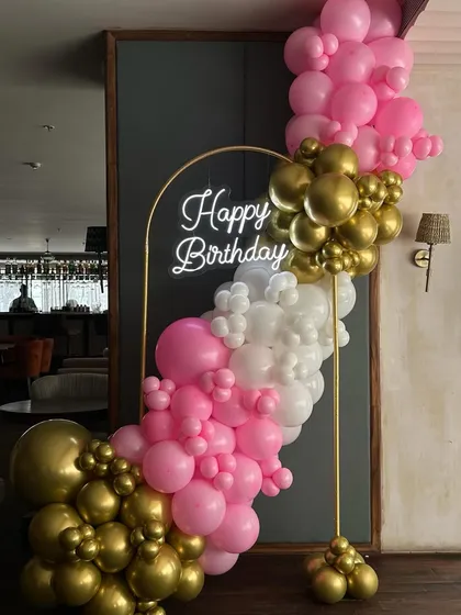 A closer look at our mini balloon backdrop, perfect for parties in space-constrained venues. The combination of pink, white, and gold chrome balloons is both fun and elegant.