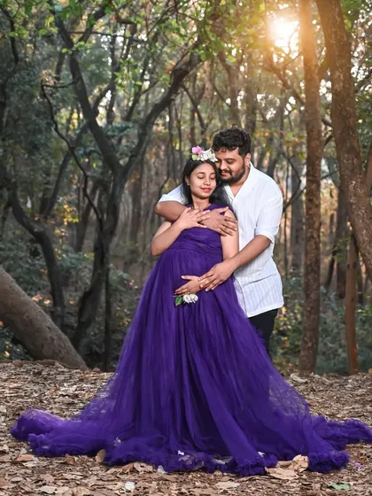 Celebrate your journey to motherhood with a romantic forest photoshoot. This deep purple maternity gown features a comfortable, bump-flattering design, and the rich color looks stunning against the natural greenery and golden hour light.