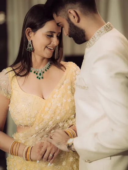 A close-up portrait focusing on the quiet intimacy between the couple. This shot highlights their elegant traditional attire and the gentle connection they share, perfect for an engagement album.