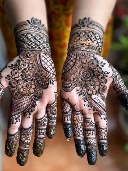 Happy Karwa Chauth. This is a popular style for the festival, with full palm coverage and detailed work on the fingers. I even hid the client's name, Risha, in the design.