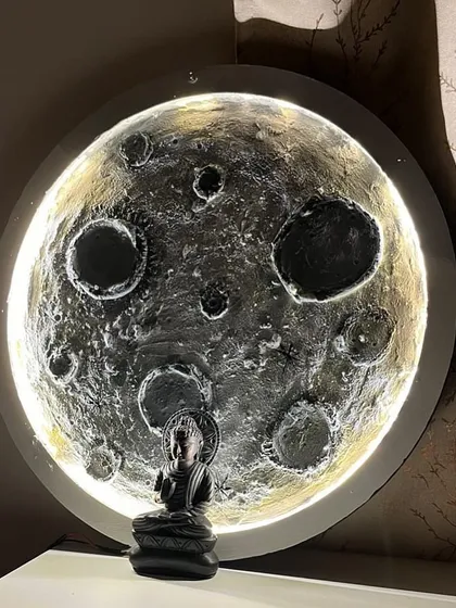 Bring the night sky into your home. Here’s a finished 3D moon lamp, created by a participant in our workshop, glowing beautifully with a small Buddha statue for a touch of serenity.