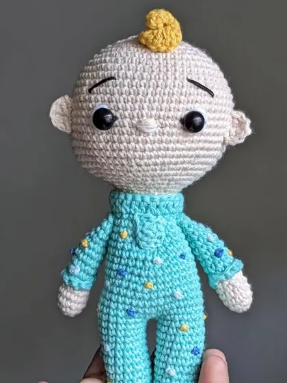 A close-up of the JJ Cocomelon doll.