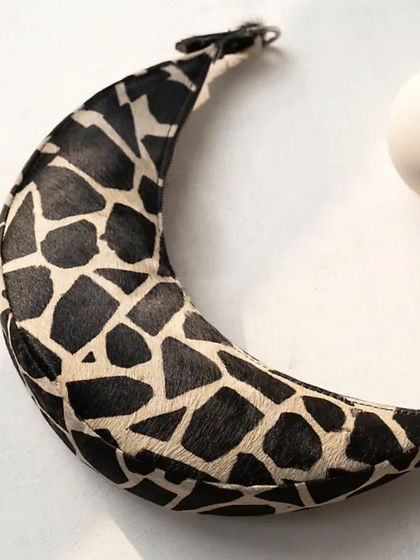 A close-up of the Selena in a classic two-tone cattle print. The hair-on leather provides a unique texture, making it a standout piece that is still neutral enough for everyday wear.