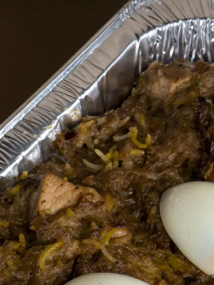 A bulk tray of my flavorful biryani, garnished with boiled eggs. This is how I prepare large orders for parties, ensuring every portion is delicious.