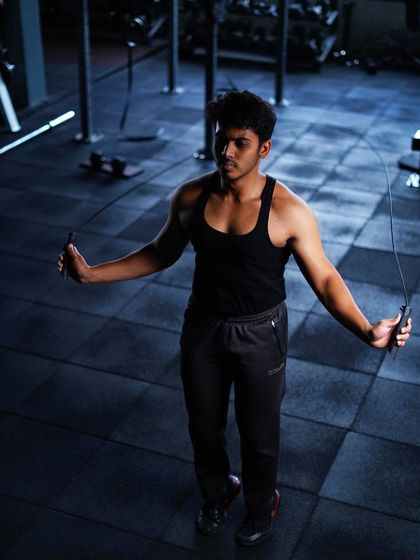 A member warms up with a jump rope, an excellent cardio tool for improving coordination and endurance before a strength session.