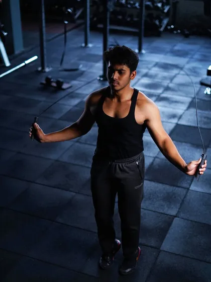 A member warms up with a jump rope, an excellent cardio tool for improving coordination and endurance before a strength session.