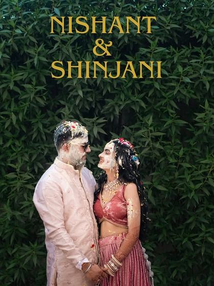 A stylish portrait of the couple during their Haldi, standing against a lush green wall, creating a beautiful contrast.