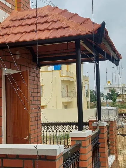 A small balcony with a sloping Mangalore tile roof, providing a cozy, sheltered outdoor spot.