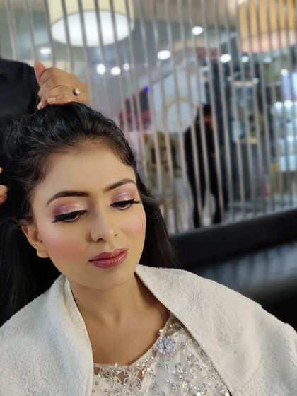 Another view of the makeup application, showing the attention to detail in blending and creating a seamless base.