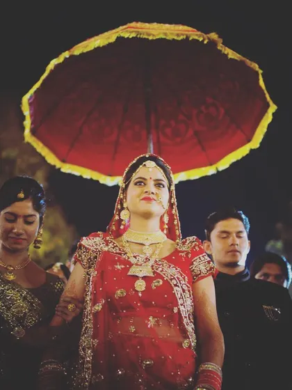 The bride's entrance is a grand and regal moment. I captured her entry under a traditional umbrella, using the lighting to create a majestic feel that highlights her poise and the significance of the ceremony.