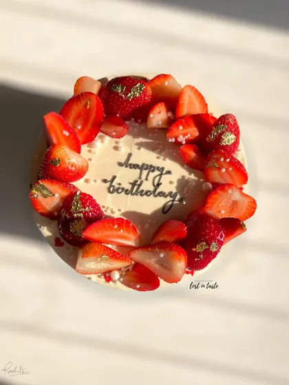 A seasonal favorite, this Vanilla Strawberry cake is topped with fresh strawberries, edible gold leaf, and tiny sugar pearls. It's available as a celebration cake or a smaller bento cake.