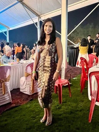 Our client Devika carries off her custom-made Benaras fabric halter dress with poise at an evening event.