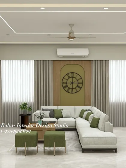 A comfortable L-shaped sofa is paired with olive green accents and a large statement clock. This design choice shows how to use color to define a space while maintaining an overall neutral and relaxing palette.