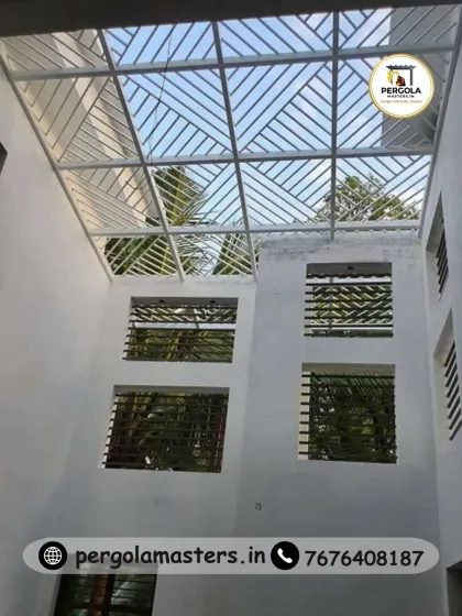 A large skylight with a clean, linear grid pattern installed in a courtyard. This design provides shelter while allowing ample daylight to enter the open space, making it usable in various weather conditions.