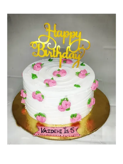 A simple and pretty floral cake for Vaidehi's 5th birthday. This fresh pineapple cake is decorated with small pink rosettes.