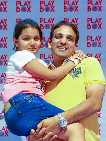 A father and daughter pose for a photo at our Father's Day event. We love celebrating super dads.