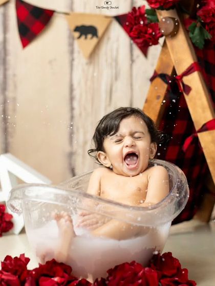 A big splash and a funny face make this camping-themed milk bath photo a memorable one.