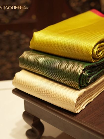 We stock a wide range of silks for every taste. This stack shows the beautiful sheen of our plain silk collection in vibrant yellow, green, and cream.
