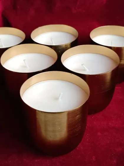 An overhead view of the set of six brass jar candles.