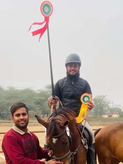 A rider and his horse posing with their winnings from the Junior National Equestrian Championship 2024. He secured gold medals in individual all over, lemon and peg, and ring and peg events.
