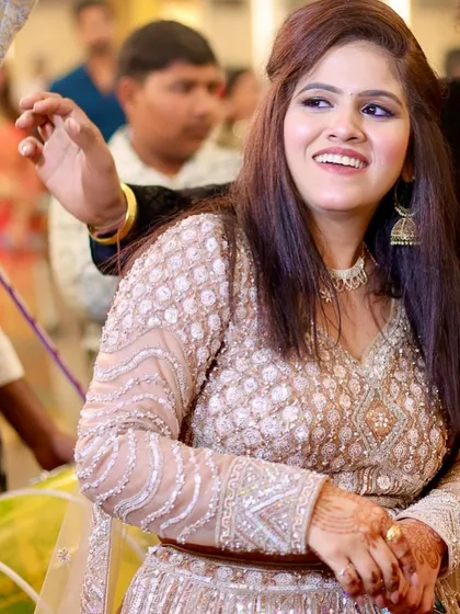 A happy, candid shot from the event. Her smile and glowing makeup light up the photo.