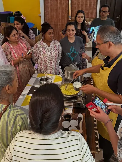 Participants gather around to watch a cooking demonstration. These workshops are interactive, allowing everyone to learn the techniques and principles of a yogic diet.