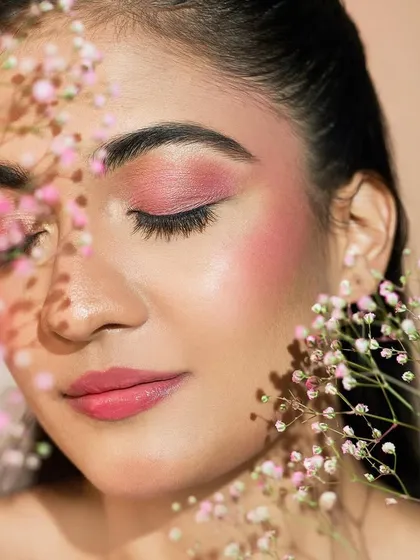 A serene portrait with the flowers gently obscuring parts of the face, creating a dreamy and artistic composition.