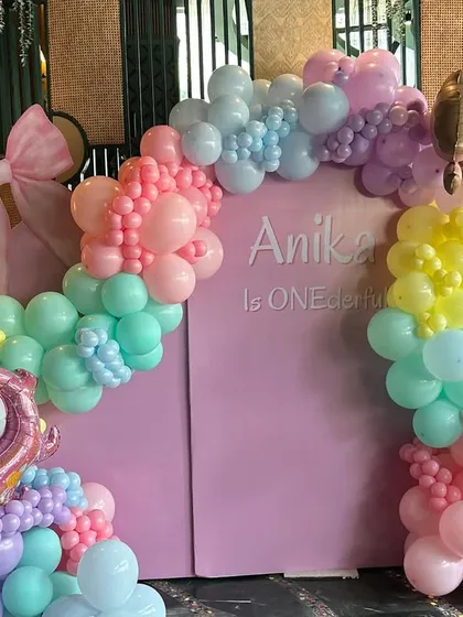 A 'ONE-derful' first birthday filled with unicorn magic. This vibrant pastel rainbow balloon arch, complete with a unicorn and ice cream cone accents, creates a playful and dreamy backdrop for a little one's special day.