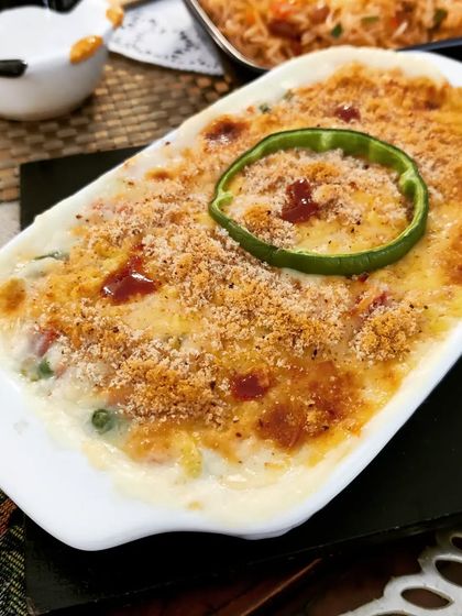 An all-time favourite, our Vegetable Au Gratin is rich, creamy, and satisfying. A mix of vegetables in a cheesy white sauce is baked with a crispy breadcrumb topping.