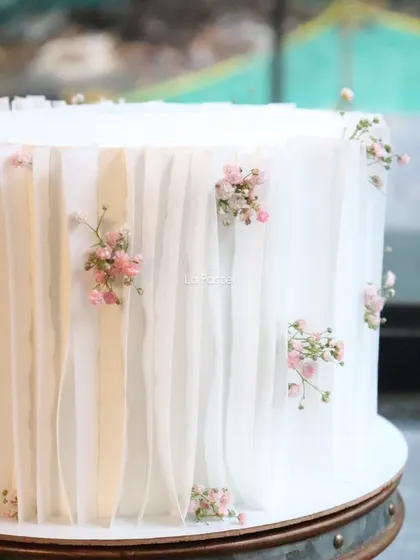 The soft, translucent quality of wafer paper gives this cake an ethereal, fabric-like appearance.