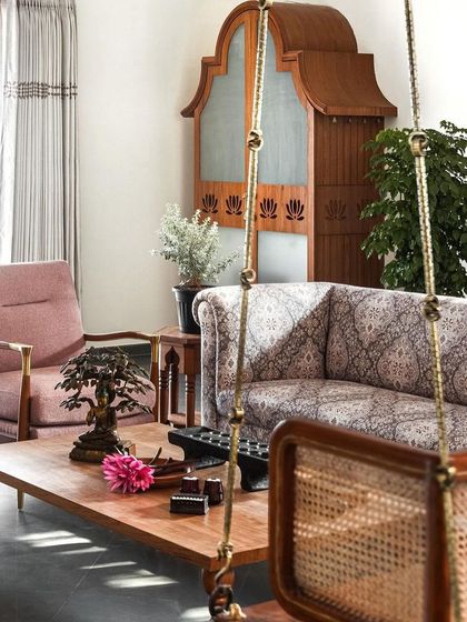 The living room seating arrangement, with its mix of patterned and solid fabrics, reflects the comfortable and inviting atmosphere of the Prangan home.