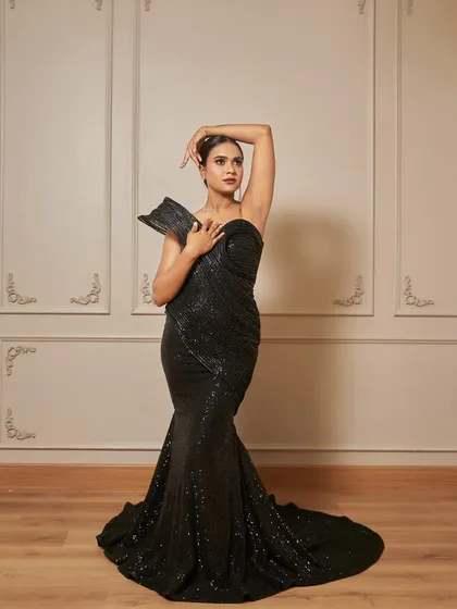 A powerful and confident pose in our Fantasia gown. This dress is perfect for creating a bold and unforgettable look.