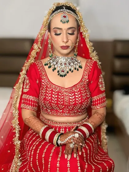With her eyes closed, you can see the soft blending of the eyeshadow and the flawless base. This is a classic bridal makeup look that enhances her features beautifully.