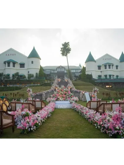 The wedding aisle at the Savoy in Mussoorie, ready to welcome guests. The combination of elegant seating, a flower-laden path, and the stunning backdrop showcases our approach to creating immersive and beautiful ceremony environments.