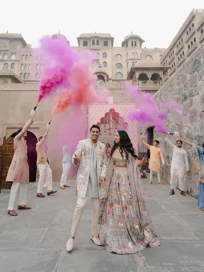 A pastel wonderland comes to life with bursts of pink and purple smoke. This shot from a pre-wedding celebration at Fairmont Jaipur showcases our ability to create dynamic, colorful, and joyful moments.