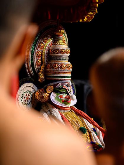 Another creatively framed portrait, offering a glimpse of the performer's intense expression and detailed makeup.