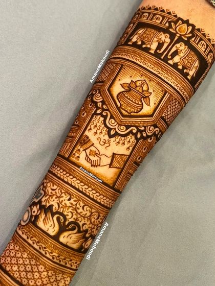 A full bridal arm design featuring bands of elephants, swans, and the sacred 'hathleva' (joining of hands) ceremony, symbolizing the couple's union.