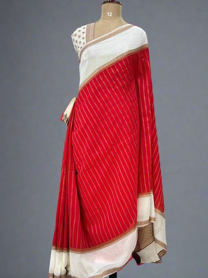 A mannequin draped in the red and white version of our semi-wrinkle crepe saree.