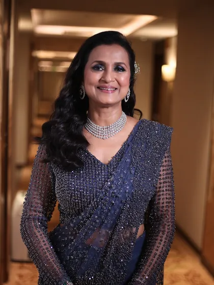 A beautiful, confident portrait. The makeup enhances her features with a focus on bright eyes and glowing skin, proving that glamour has no age limit.