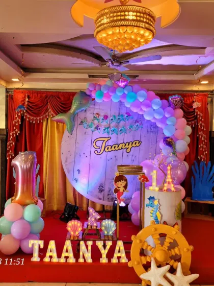 Another take on the mermaid theme, this time for Taanya's first birthday, with a rustic wooden backdrop and pastel balloons.