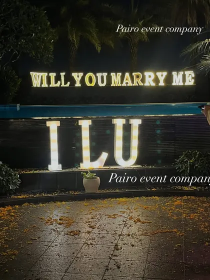 This shot shows the combination of "WILL YOU MARRY ME" and "I L U" marquee letters, offering a personalized and direct message for the big question.